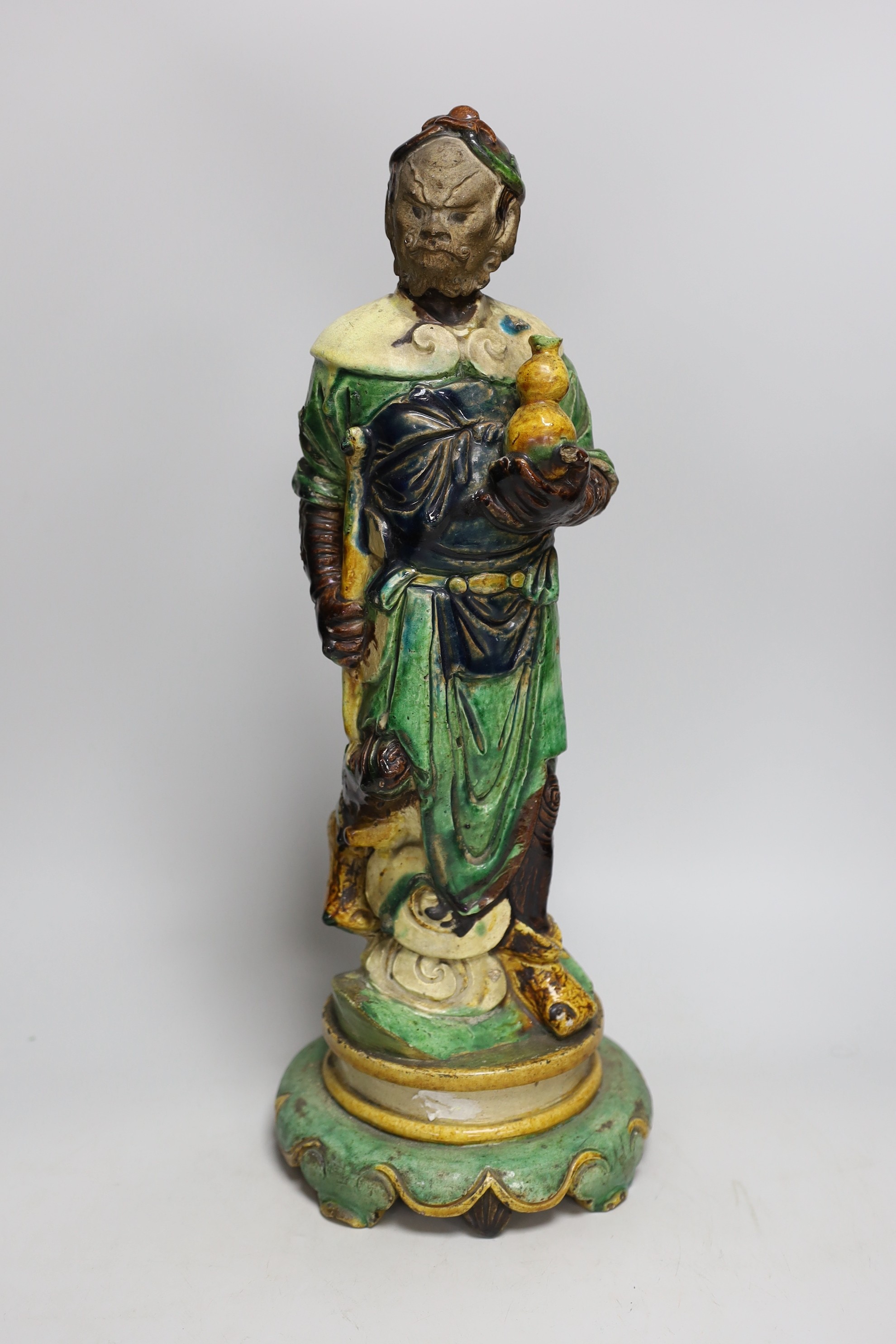 A Chinese sancai glazed figure of Li Tieguai, probably Ming dynasty, 45.5cms high